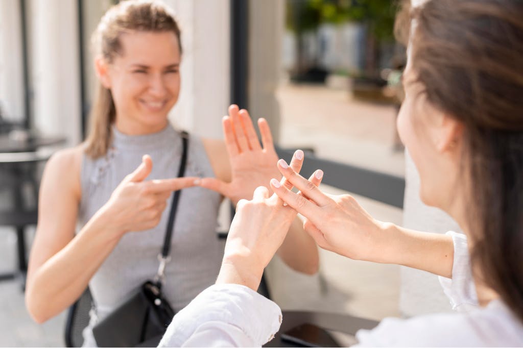 Deaf women communicating through sign language