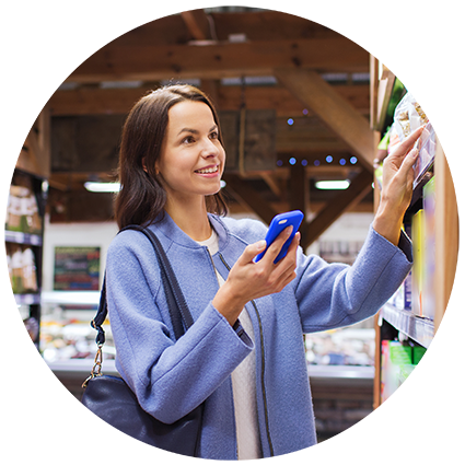 White women in blue coat holding phone in shop 