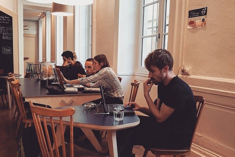 Cafe with group of people working on laptops