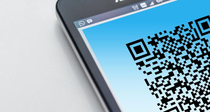 Close-up of a smartphone screen displaying a QR code against a blue background.