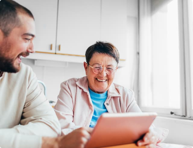 Young man & old women smiling